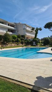 a large swimming pool in front of a building at Casa Orquídea in Platja d'Aro