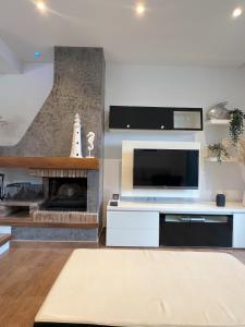 a living room with a tv and a fireplace at Casa Orquídea in Platja d'Aro