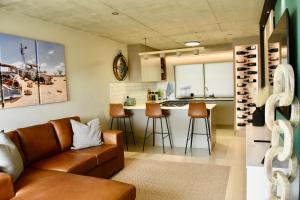 a living room with a couch and a kitchen at Rustic Hills #19 Self-catering accommodation in Swakopmund