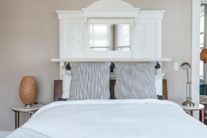 a bedroom with a white bed with two pillows at CHIC Thames Harbor free parking in Newport