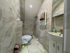 a bathroom with a toilet and a sink at Тихое место 