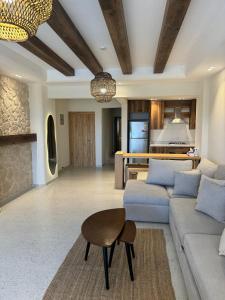 a living room with a couch and a table at La Vista Bay - Chalet in Dawwār Ḩājj as Sayyid Rizq