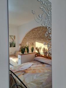 a bedroom with a bed with plants on it at Casa La Graziosa Soverato in Soverato Marina +36 photos