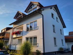 a white building with windows and a balcony at Bodensee Idylle in Friedrichshafen