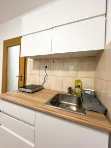 a kitchen counter with a sink and a microwave at Modern Central Studio - 3 min walk to lake in Ohrid