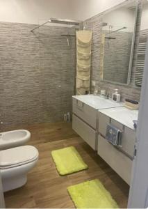 a bathroom with a toilet and a sink and a mirror at Casa Biancola, Novara Centro in Novara +44 photos
