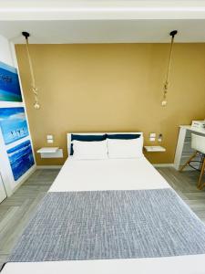 a bedroom with a large white bed in a room at Aquamarì Charme Rooms in Vieste