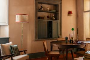 a dining room with a table and a chair at Villa Gamberaia in Settignano