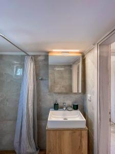 a bathroom with a sink and a shower at House 2BD Private Parking Next to Center in Asprovalta +40 photos