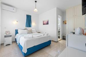 a bedroom with a blue and white bed in a room at Hotel Selini in Agios Nikitas