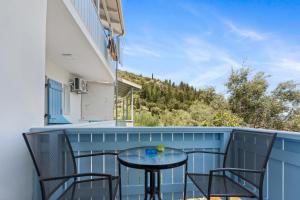 a patio with a table and chairs on a balcony at Hotel Selini in Agios Nikitas