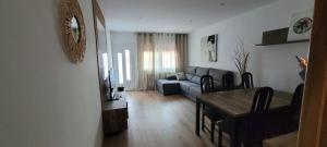 a living room with a couch and a table at Chalet Avenida El Barraco Avila in El Barraco