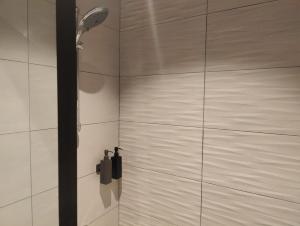 a shower with a shower head in a bathroom at Prime Suites in Al Khobar