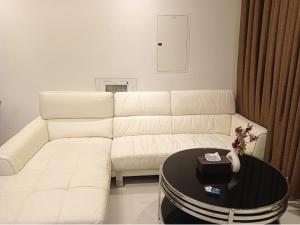 a living room with a white couch and a table at Cozy Beautiful Private Room with Shared Washroom in Ajman 