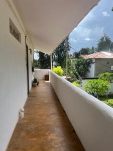 a white balcony with a view of a yard at Siri Beach Lodge in Nungwi