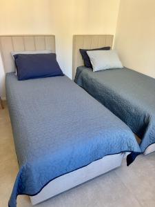 two beds sitting next to each other in a room at Sunny Old Town Apartment in Koper