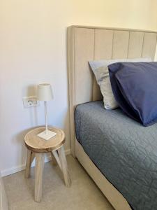 a bedroom with a bed and a table with a lamp at Sunny Old Town Apartment in Koper +24 photos
