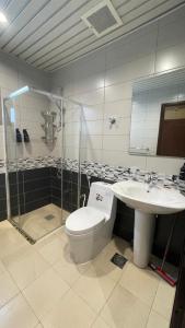 a bathroom with a toilet and a sink at life style apartment in Dhahran