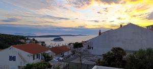 a person is standing on the side of a building at Apartments Slijepcevic in Hvar