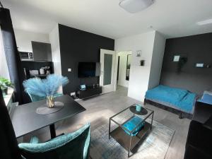 a living room with a table and a couch at Apartment Nr 15 in Bremerhaven