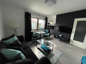 a living room with a couch and a table at Apartment Nr 15 in Bremerhaven