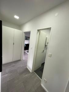 an empty room with white cabinets and a mirror at Apartment Nr 15 in Bremerhaven