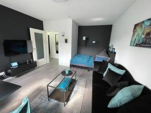 a living room with a couch and a table at Apartment Nr 15 in Bremerhaven +1 photo