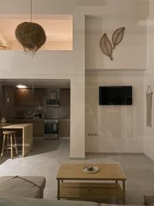 a living room with a couch and a table at Cosy Nest In Samos in Samos