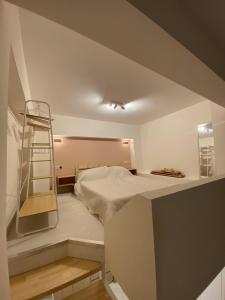 a bedroom with a bed and a ladder in it at Cosy Nest In Samos in Samos