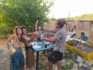 a group of women standing around a table with a man at Pinwheel Hostel Vlora & Rooftop Bar in Vlorë +40 photos