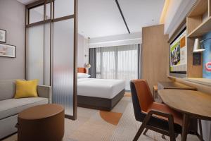 a hotel room with a bed and a desk at Home2 Suite by Hilton Hengshui Taocheng in Hengshui