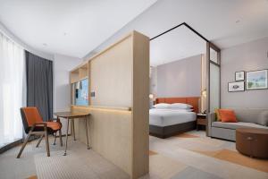 a hotel room with a bed and a desk at Home2 Suite by Hilton Hengshui Taocheng in Hengshui
