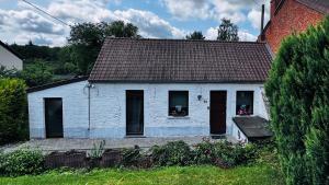 a white house with black windows and a brown roof at Au coron des Anges - Havré - Mons - Pairi Daiza - Shape in Mons