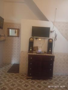 a tv sitting on top of a dresser in a room at Dar manena in Kairouan