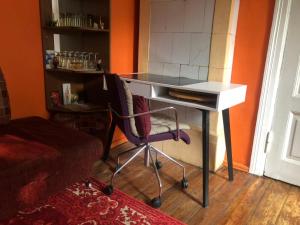 a desk with a chair in a room at Authentic apt in a rustic house, best for a person or couple in Rīga