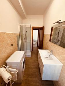 a bathroom with a sink and a shower and a mirror at Appartamento cittadella in Verona +14 photos