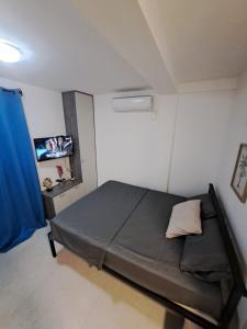 a small bedroom with a bed in a room at Kustudic Apartments in Tivat