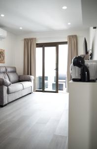 a living room with a couch and a television at Los Cristianos Aqua Viva in Los Cristianos