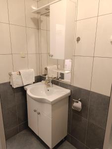 a bathroom with a sink and a mirror at Apartments Slijepcevic in Hvar +20 photos
