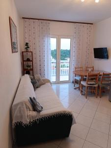 a bedroom with a bed and a dining room with a table at Apartments Slijepcevic in Hvar