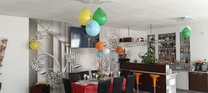 a dining room with a table and balloons hanging from the ceiling at Vila Bella Tarlungeni in Tărlungeni