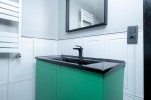 a bathroom with a green sink and a mirror at Fourlex Single Detached House - 2 Bathrooms - Central Location - Private Terrace in Istanbul +38 photos