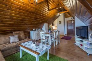 a living room with a couch and a table at Apartament Murzasichle Gościna na Wierchu in Murzasichle