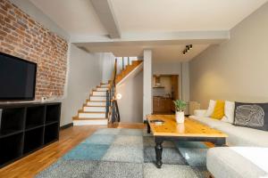 a living room with a brick wall at Fourlex Single Detached House - 2 Bathrooms - Central Location - Private Terrace in Istanbul