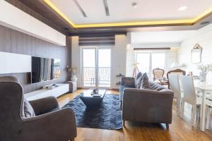 a living room with couches and a dining room at Apartments Hana 2 in Pržno