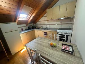 a kitchen with a table with a bowl of fruit on it at Lefkas Rooftop in Lefkada