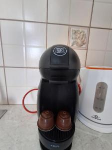 a coffee maker sitting on a counter with chocolates at Vista del Mare Rooms 1 in Agios Ioannis Kaspaka