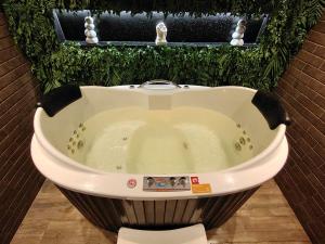 a large bath tub sitting in a room at La Dolce Vita in Maceió +16 photos