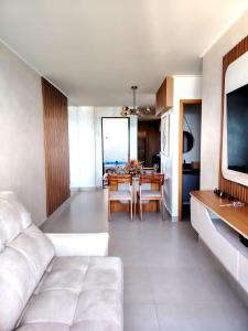 a living room with a white couch and a table at La Dolce Vita in Maceió