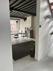 an open doorway to a room with a table and chairs at Cloud9 in Bergen op Zoom